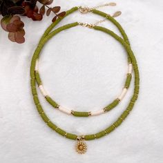 Heishi necklace, olive green necklace, Heishi boho necklace, dainty flower necklace, simple beaded necklace, summer bead necklace. These boho chic chokers are very trendy and they match with your daily outfit. If you are looking for stylish summer necklace to enhance your daily outfit, you found them! They're easy to wear everyday alone or layered with other favorite necklaces. 💕 ITEM DETAILS: Length: 14 - 16 inches. The length of the necklace refers to the total length from end-to-end. Materia Bohemian Flower Necklace With Round Beads For Beach, Bohemian Beach Flower Necklace With Round Beads, Bohemian Necklace With Flower Charm And Round Beads, Dainty Flower Charm Necklace For Summer, Dainty Green Jewelry For Beach, Dainty Summer Necklace With Flower Charm, Adjustable Green Flower Necklace With Round Beads, Bohemian Beaded Necklace With Flower Charm For Summer, Green Bohemian Flower Charm Necklace