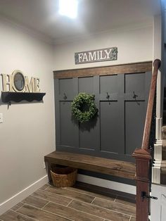 a entryway with a bench and wreath on the wall