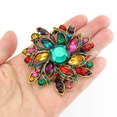 Gorgeous vibrant rhinestone brooch embellishment, which can be used for your DIY project - Vintage wedding, bridal brooch bouquet, ring pillow, gown sash, bridesmaid dress, invitations, cake and frame decorations, event decor, crafts, scrap booking, jewelry gift and much more! Size: 2 1/2 inch high 2 1/2 inches wide Rhinestone color: mix multi color, rainbow Metal: dark gold plated This rhinestone round broach can be ordered with pin in the back to wire into brooch bouquet, add to wedding gown o Multicolor Rhinestone Brooches For Wedding, Multicolor Rhinestone Wedding Brooches, Bouquet Ring, Bridal Brooch Bouquet, Rainbow Metal, Antique Costume Jewelry, Brooch Bouquet, Brooch Bouquets, Ring Pillow