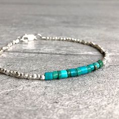 Real Turquoise Bracelet | Tiny Bead Bracelet | Sterling Silver Turquoise Crystal Jewelry | Men's, Women's Custom Size Stacking Bracelet by GemsByKelley on Etsy https://www.etsy.com/listing/593163812/real-turquoise-bracelet-tiny-bead Minimalist Turquoise Beaded Bracelet With Gemstones, Minimalist Turquoise Gemstone Beaded Bracelet, Turquoise Beaded Bracelets With Spacer Beads For Everyday, Turquoise Beaded Bracelet With Spacer Beads, Minimalist Beaded Turquoise Bracelet, Minimalist Turquoise Beaded Bracelets, Minimalist Turquoise Beaded Bracelet, Hand-strung Turquoise Minimalist Bracelets, Minimalist Turquoise Bracelet With Gemstone Beads