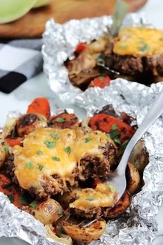 two foil packets filled with food on top of a table