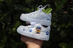 Say hello to our Paw Patrol Toddler Boy Air Force 1 Low Custom Kids Shoes! Featuring vibrant Paw Patrol designs hand-painted onto these AF1 sneakers, they're perfect for his everyday escapades. These kicks are as comfy as they are cool, ensuring he's ready for any adventure. Shop now and watch his style take flight! Hand/spray painted paw patrol boy design. Personalize with name (optional) Resistant clear coat (protected against cracks and scratches). Custom made-to-order sneaker. Brand new 100% authentic Nike AF1 Low with box! Free shipping within the US territory! Need a different color? Let us know which color you're looking for and we'll find it for you. Have an idea for your custom painted sneakers? Please send us a message here. We'll get back to you within 48hrs! Custom Baby Shoes, Paw Patrol Shoes, Personalized Sneakers, Angelus Paint, Painted Sneakers, Shoes Diy, Low Shoes, Custom Air Force 1