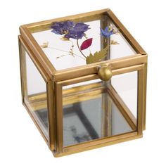 a small glass box with flowers in it