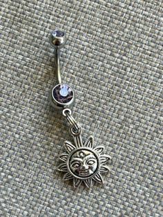 This super cute belly button ring features a silver sun charm that hangs from a standard 14 gauge surgical steel barbell with a double light purple gem.  It measures  approx. 1 inch long.  Thanks for taking a look!   *If you would like this belly button ring in a different color gem or stone, just leave at note at checkout! I would love to make it for you!* Adjustable Nickel-free Stainless Steel Belly Rings, Adjustable Hypoallergenic Silver Belly Rings, Adjustable Silver Surgical Steel Belly Rings, Adjustable Hypoallergenic Stainless Steel Belly Rings, Adjustable Nickel-free Dangle Belly Rings, Adjustable Internally Threaded Silver Belly Rings, Hell Lila, Sun Charm, Purple Gems