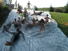 a group of people laying on top of a tarp