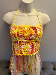 Crocheted bohemian top. One size fits most. Bohemian Multicolor Crop Halter Top, Bohemian Crop Top For Music Festival, Bohemian Halter Top For Music Festivals, Hippie Festival Crop Top, Hippie Crop Top For Music Festival, Hippie Cropped Tops For Spring, Bohemian Multicolor Halter Top For Festival, Sleeveless Fringe Top For Beach Season, Bohemian Multicolor Tops For Music Festival