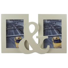 two white frames with an amp and yellow bus on the tracks in front of them