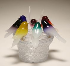 three glass birds sitting on top of each other