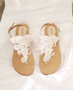 White lace bridal sandals are designed with feminine lace design. They are perfect for your Destination Wedding or a comfortable alternative for traditional brides. The comfortable wedding sandals are vegan friendly. They are perfect for wearing at your reception so you can dance the night away in comfort! After the wedding wear them all summer long. The lace is white and the sandal straps are an off white/neutral color. Additional beach inspired items can be found in my shop http://www.etsy.com White Lace Wedding Shoes With Ankle Strap, White Lace Ankle Strap Wedding Shoes, Elegant Lace Open Toe Sandals, Elegant Lace Sandals For Summer, Cream Open Toe Sandals For Bridal Shower, Cream Closed Toe Sandals For Wedding, Summer Wedding Ceremony Shoes With Ankle Strap, Summer Wedding Closed Toe Shoes For Ceremony, Summer Wedding Open Toe Shoes For Ceremony