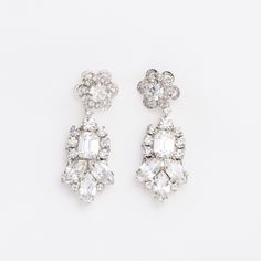 Meet our stunning LALE Earrings with Swarovski crystals. Featuring round and marquise shaped Swarovski crystals creating a unique design and a gorgeous pair of earrings! The LALE Earrings are a daintier version of our CEMILE earrings!. Our LALE Earrings are a perfect pair to add the right amount of sparkle to your look on your special day! The shine on these earrings is impeccable. Handcrafted with the Highest Quality Materials Swarovski Crystals Platinum plated - Guards against scratches and ta Sparkling Dazzling Crystal Earrings, Crystal Cluster Drop Earrings With Sparkling Stones, Dazzling Crystal Embellished Cubic Zirconia Earrings, Formal Crystal Cluster Earrings With Sparkling Stones, Crystal Drop Clip-on Earrings With Sparkling Stones, Dazzling Sparkling Crystal Cluster Earrings, Crystal Embellished Drop Earrings, Classic Crystal Earrings In Diamond White, Classic Crystal Earrings With Sparkling Stones