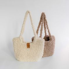 three purses are lined up against a white background