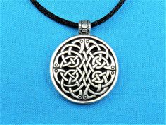 "Welcome! This listing is for a circular necklace medallion featuring a simple Quaternary Tri Celtic knot work that was handmade and cast by my Husband and I. This is made with silver pewter, and is 100% lead-free! Larger version of this pendant: https://www.etsy.com/listing/590459642/quaternary-tri-celtic-knotwork-pendant?ref=shop_home_active_1 It measures: 1 1/8 inches in diameter (1 1/2 inches tall including the necklace hanger / bail) , or 29 mm in diameter (39 mm including the necklace bail Adjustable Nickel Free Medallion Necklace, Symbolic Adjustable Necklace With Oxidized Finish, Symbolic Necklace With Oxidized Finish, Symbolic Necklace With Oxidized Finish And Adjustable Fit, Silver Medallion Hand Cast Necklace, Silver Medallion Necklace Hand Cast, Adjustable Medallion Necklace With Oxidized Finish, Hand Cast Silver Medallion Necklace, Adjustable Silver Pendant Medallion Necklace