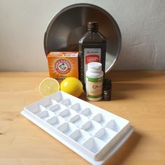 ingredients for making lemonade sit on a table next to an ice tray and container