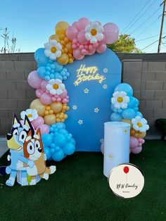 an outdoor birthday party with balloons and decorations