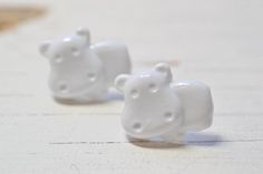 Adorable bright white hippo earrings! These hippos are lightweight plastic and are securely attached to stainless steel.Hippo earrings are 16mm wide and 12mm tall.Click here for more of my handmade jewelry: http://lotusandbliss.etsy.com Cute Hippopotamus, Motivational Jewelry, Purple Succulents, Vegan Jewelry, Hungry Hippos, Dinosaur Earrings, Sparkly Jewelry, Pumpkin Earrings, Botanical Jewelry