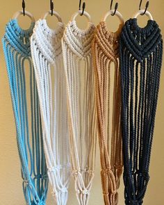 four different colored ropes hanging from hooks