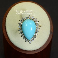 Pretty Levian Sleeping Beauty Turquoise diamond ring, This cabochon is cut in a cute teardrop shape and has a halo of round brilliant diamonds. Ring Size: 7 Total Weight: 8.31 grams Precious Metal: 14k yellow gold Precious stones: -Sleeping Beauty Turquoise Center Stone: 17mmx11.5mm, 13.8 carats -White Round Diamonds: 0.63 carats Hallmark: Levian, 14k Elegant Turquoise Cabochon Diamond Ring, Gift Diamond Turquoise Cabochon Ring, Elegant Turquoise Teardrop Ring For Anniversary, Elegant Turquoise Teardrop Rings, Turquoise Diamond Ring, Turquoise Diamond Rings, Gold Vintage Ring, Teardrop Diamond, Platinum Diamond Rings