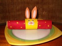 a paper roll with bunny ears sticking out of it sitting on top of a plate