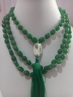 108 Beads AAA 968 Carat Emerald Dyed Japa Mala Prayer Green Color Oval Beads Japa Mala Guru bead Necklace // Long Tassel Necklace// Meditation japa mala // Guru bead// Necklace Yoga Beads Stone - Emerald Dyed Shape - Oval Size - Approx - 10x12mm Colour - Green It is known as the 'love stone' as the message it emits is the strong vibration of unconditional love, joy, warmth and healing. As quartz crystals are profound amplifiers of energy, it may help to kindle happiness, love, romantic feelings Spiritual Beaded Necklace With Faceted Oval Beads, Spiritual Beaded Necklaces With Faceted Oval Beads, Handmade Oval Spiritual Beaded Necklaces, Spiritual Jade Beaded Necklaces With Polished Beads, Spiritual Jade Beaded Necklace With Polished Beads, Bohemian Jade Beaded Necklace With 108 Beads, Jade Beaded Necklaces With Gemstone Beads For Meditation, Beaded Agate Mala With Round Beads, Green Gemstone Beads Mala