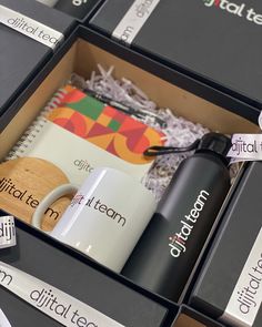 coffee mugs and other personal items are in the box with labels on them that read digital team