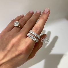 a woman's hand with two rings on it