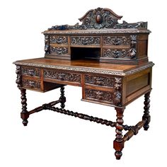 an old wooden desk with ornate carvings on the top and bottom drawers, sitting against a white background