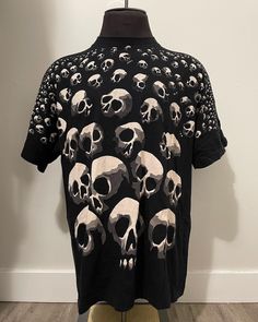 "Skull Pile Tshirt  - All over print  - Washed out tag (unknown branding) - Single stitch  - Skull pile graphic  Size: XL 23\" pit to pit  30\" shoulder to waist  Good condition  No rips or holes  No stains" Urban Skull Print Crew Neck Top, Urban Short Sleeve Tops With Skull Print, Urban Cotton Tops With Skull Print, Casual Tops With Skull Graphic Design, Cotton Tops With All Over Print Band Merch Style, Cotton Tops With All Over Print Band Merch, Grunge All Over Print Crew Neck Tops, Grunge Crew Neck Top With All Over Print, Alternative Tops With Skull Graphic Print