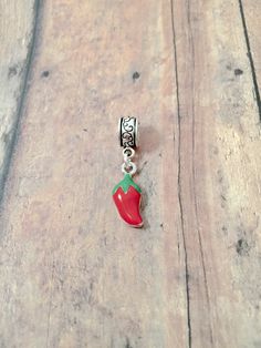 "Cute little chili pepper pendant on European style bail. (1 sided) You will receive 1 pendant. The chili pepper pendant is red enamel and silver plated and the bail is silver plated base metal. Perfect for necklaces, charm bracelets, zipper pulls, or other crafting needs! Approximate size:  1/2\" x 2/5\" bail & 4/5\" x 1/3\" chili pepper pendant. Made in USA" Red Dangle Charms With Lobster Clasp, Food Charms, Tyler Tx, Chili Pepper, Zipper Pulls, European Style, Charm Bracelets, Base Metal, European Fashion