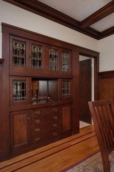 a dining room table and chairs in front of a wooden china cabinet