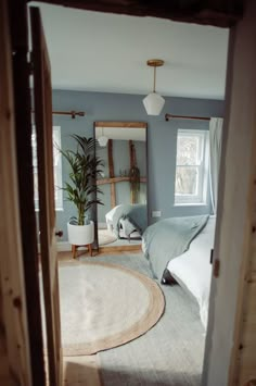 an open door leading to a bedroom with blue walls