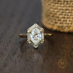 a diamond ring sitting on top of a wooden table