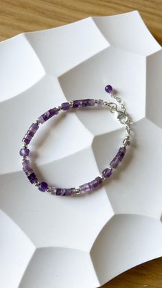 Shiny violet amethyst bracelet. It's original jewelry, beaded by hand, using only natural stone beads. Check my shop to see more matching bracelets:  https://www.etsy.com/shop/JewelsByMuzA?ref=shop-header-name&listing_id=1664043490&from_page=listing§ion_id=47678614 LENGTH: 15 cm + 3 cm chain. CLOSURE: lobster claw. MATERIALS: 4mm faceted amethyst square beads, furniture can be: stainless steel, goldened stainless steel or 925 silver. PLEASE NOTE, COLORS might be different because of the nature o Gift Amethyst Gemstone Beaded Bracelets, Amethyst Gemstone Beaded Bracelets As Gift, Amethyst Gemstone Beaded Bracelets For Gift, Amethyst Gemstone Beads Bracelets As Gift, Amethyst Gemstone Beaded Bracelet Gift, Sterling Silver Spiritual Beaded Bracelets With Gemstones, Spiritual Sterling Silver Beaded Bracelets With Gemstone, Amethyst Gemstone Beads Bracelet As Gift, Amethyst Gemstone Beads Bracelet For Gifts