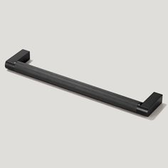 an image of a black towel bar on the wall in front of a gray background