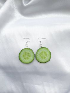 Cucumber slice ornament fun food earrings Include : 1 pair of earrings These earrings are made out of felt fabric. ○ Lenght  : 2.3'' (with hook) 1.3"x 1.3"(the cucumbre) ○ Color : green ○ Materials :  earring hook, felt fabric, sublimation ink,  metal ring, glue ○ Design and made in Latvia ♥ If you need any costumized items, please contact me. Cucumber earrings, Fun food earrings, Vegetable jewelry, Cucumber ornament, Weird earrings, Vegetable earrings, Funny vegetable, Cucumber charm, Vegetable Weird Earrings Aesthetic, Vegetable Earrings, Silly Earrings, Vegetable Jewelry, Weird Earrings, Crazy Earrings, Funny Vegetables, Earrings Funny, Weird Jewelry