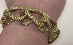 "Givenchy brushed gold, matte gold, satin gold  twisted wire link bracelet  Very good condition size - 7.75\" with clasp x 1\".   Photo: my wrist is 6.75\"  Marked: copyright symbol Givenchy Paris - New York." Matte Gold Metal Bracelet, Formal Metal Chain Bracelet With Gold Clasp, Metal Chain Bracelet With Gold Clasp For Formal Occasions, Formal Chain Bracelet With Gold Clasp, Gold Chain Link Bracelet With Clasp, Gold Link Bracelet With Clasp, Party Gold Bracelets With Lobster Clasp, Gold Party Bracelets With Lobster Clasp, Adjustable Formal Chain Bracelet With Clasp