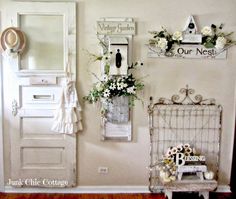 a room with a white door and some flowers on the wall next to a bench