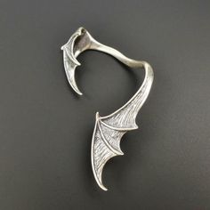 SINGLE LEFT SIDE large vampire bat wing ear climber! Fantastic design with amazing details! Handmade from solid sterling silver. The surface is slightly brushed and oxidized to create depth and texture. Fantasy Metal Ear Cuff For Gift, Halloween Claw-shaped Jewelry Gift, Halloween Jewelry Gift With Claw Shape, Halloween Gift Jewelry With Claw Shape, Silver Fantasy Style Ear Cuff For Gift, Silver Fantasy Style Ear Cuff As Gift, Gothic Winged Jewelry For Gifts, Gothic Winged Jewelry Gift, Gothic Claw Shaped Jewelry Gift