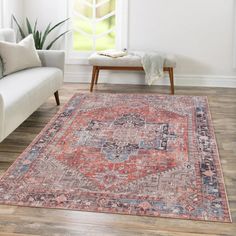 a living room with a couch, chair and rug