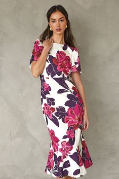 This elegant, midi dress has a slimming structure and bold, flutter sleeves. The modest shape is decorated in pink and purple florals. Midi Dress Floral Short Sleeve Length: 47" Chest: 17 1/4" Waist: 14" Self: 100% Polyester Linning: 100% Polyester Hand wash in cold water. Dry flat. Iron on low heat. Model is wearing a size S Style #: F248D6035 Midi Dress Short Sleeve, Midi Dress Floral, Elegant Midi Dress, Knit Swimwear, Cocktail Attire, Dresses Xxl, Floral Print Midi Dress, Short Dresses Casual, Midi Short Sleeve Dress