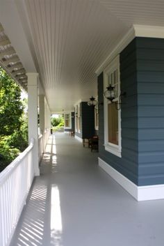 a porch with blue siding and white trim