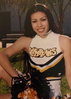 a cheerleader posing for a photo with her hands on her hips