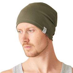 a man wearing a green beanie hat