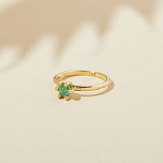 "MAY BIRTHSTONE RING WITH EMERALD May's emerald stone is as magnetic as its wearers. Powerful in its confidence-boosting nature and ability to captivate, emeralds are known to ignite passion and elevate any mood and outfit. Our Birthstone Ring is adorned with a genuine gemstone and cradled by bright yellow bronze or sterling silver. Each one is supported by prongs resembling flower petals in bloom. Stack it, admire it, wear it daily. Your ring is more than an accessory: it is an heirloom of hono Emerald Birthstone Ring, Gemstone Stacking Ring, Ring With Emerald, Pink Garnet, May Birthstone Rings, Emerald Birthstone, May Birthstone, Orange Sapphire, Ring Minimalist