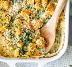 a casserole dish with cheese and spinach