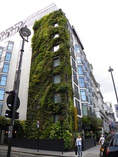 a tall building with plants growing on it's side