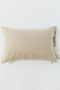 the linen pillow is tied up and ready to be used as a decorative decoration piece