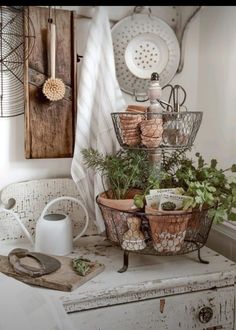 an old dresser is filled with potted plants and kitchen utensils on it