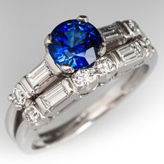 a blue diamond ring with baguets and diamonds around it