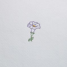 a single flower is embroidered onto the white paper