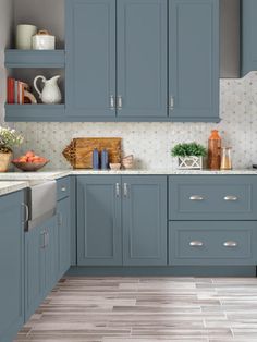 an image of a kitchen setting with blue cabinets